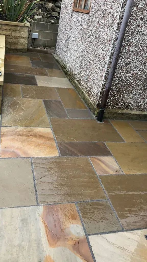 Indian paving stones running along the house wall towards the back of the property