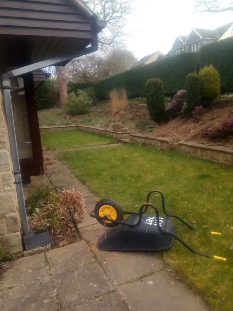 The garden as it stood before the build, with a wheelbarrow on the old paving